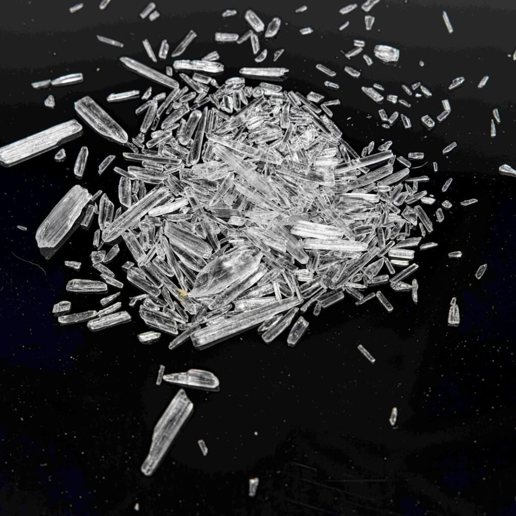 a pile of glass shards on a black surface